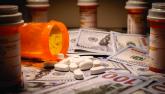 pill bottles and pills on money